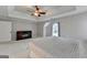 Spacious main bedroom with a ceiling fan, tray ceiling, and a large window at 925 Whitehawk Trl, Lawrenceville, GA 30043