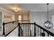 View of the staircase with wrought iron bannister and a view of the upstairs hallway at 925 Whitehawk Trl, Lawrenceville, GA 30043