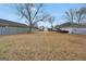 Fenced backyard with grassy lawn, storage shed, and mature trees offering plenty of space for outdoor activities at 11531 E Lovejoy Rd, Hampton, GA 30228