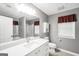 Well-lit bathroom with modern vanity, tiled floors, shower, and neutral paint at 11531 E Lovejoy Rd, Hampton, GA 30228