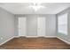 Well-lit bedroom with wood-look floors, two closets, and large window at 11531 E Lovejoy Rd, Hampton, GA 30228