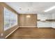 Light-filled dining room with wood-look floors, modern chandelier, and a view into the kitchen at 11531 E Lovejoy Rd, Hampton, GA 30228