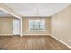 Formal dining room with wood floors, a modern light fixture, and a view of the yard at 11531 E Lovejoy Rd, Hampton, GA 30228
