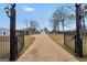 Long driveway leading to a well-maintained home with a convenient carport and an inviting curb appeal at 11531 E Lovejoy Rd, Hampton, GA 30228