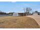 Spacious property featuring a large carport and metal building, set against a backdrop of mature trees and expansive yard at 11531 E Lovejoy Rd, Hampton, GA 30228