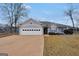 Charming home exterior with a two-car garage and lush landscaping for a welcoming curb appeal at 11531 E Lovejoy Rd, Hampton, GA 30228