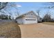 Home exterior with a large garage and wide driveway for easy access and ample parking at 11531 E Lovejoy Rd, Hampton, GA 30228