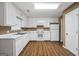 Well-lit kitchen featuring white cabinets, modern appliances, and an efficient layout for cooking at 11531 E Lovejoy Rd, Hampton, GA 30228