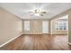 Spacious living room featuring a neutral color palette, wood-look floors, and plenty of natural light at 11531 E Lovejoy Rd, Hampton, GA 30228