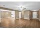 Bright living room with wood floors, a ceiling fan, and an open layout into the kitchen and entry at 11531 E Lovejoy Rd, Hampton, GA 30228