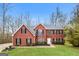 Traditional brick home featuring black shutters and a well-manicured lawn at 3167 Sw Clairide Dr, Conyers, GA 30094