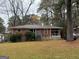 Single story brick home with stone foundation, set back from street with grass lawn at 392 Carey Se Dr, Atlanta, GA 30315