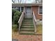 Close up of the wooden steps leading to the front door with protective metal security door at 392 Carey Se Dr, Atlanta, GA 30315