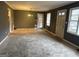 Living room with neutral carpet, gray walls, and multiple doors leading to other spaces at 392 Carey Se Dr, Atlanta, GA 30315