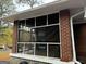 The screened porch is brick with a concrete floor and many windows at 392 Carey Se Dr, Atlanta, GA 30315
