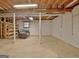 Spacious unfinished basement with exposed ceiling, concrete floors, and potential for customization at 200 Deer Forest Trl, Fayetteville, GA 30214