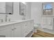 Double vanity in renovated bathroom with wood-look flooring, toilet and crisp, white walls at 200 Deer Forest Trl, Fayetteville, GA 30214