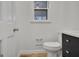 A half bathroom featuring a toilet and vanity with a modern style at 200 Deer Forest Trl, Fayetteville, GA 30214