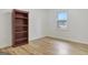 Bedroom with hardwood floors, white walls and trim, large bookshelf and view from the window at 200 Deer Forest Trl, Fayetteville, GA 30214