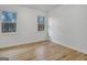 Bright bedroom with hardwood floors, white walls and trim, and two windows letting in natural light at 200 Deer Forest Trl, Fayetteville, GA 30214