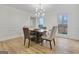 Bright dining room with modern lighting, wood floors, and view of the outdoors at 200 Deer Forest Trl, Fayetteville, GA 30214