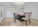 Bright dining room with modern lighting, wood floors, and decorative wainscoting at 200 Deer Forest Trl, Fayetteville, GA 30214