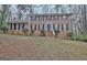 Classic brick home with a symmetrical design, white stairs, and mature landscaping at 200 Deer Forest Trl, Fayetteville, GA 30214