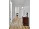 Hallway with light wood-look flooring, white walls, and white trim at 200 Deer Forest Trl, Fayetteville, GA 30214