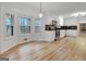 Kitchen features stainless steel appliances, white cabinetry, and wood-look flooring with a sunlit eating area at 200 Deer Forest Trl, Fayetteville, GA 30214