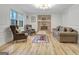 Bright living room with a brick fireplace and updated floors at 200 Deer Forest Trl, Fayetteville, GA 30214