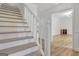 Bright foyer showcases a staircase with white banister, wood treads, and views to an adjacent room at 200 Deer Forest Trl, Fayetteville, GA 30214