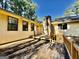 Exterior view of wooden back deck and stone chimney, perfect for outdoor relaxation and entertaining at 1327 Highway 54 E, Fayetteville, GA 30214