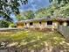 Back exterior of a home, with attached garage, mossy yard, and some fencing at 1327 Highway 54 E, Fayetteville, GA 30214