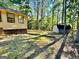 View of wooded backyard, exterior basement and shed from the side of the house at 1327 Highway 54 E, Fayetteville, GA 30214