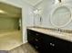 Bathroom featuring dual vanity with granite countertop and ample lighting at 1327 Highway 54 E, Fayetteville, GA 30214