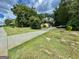 Long driveway leading to a charming home, surrounded by lush green grass and mature trees at 1327 Highway 54 E, Fayetteville, GA 30214