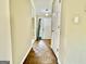 Hallway with wood flooring leading to a bright white door and sunlit room at 1327 Highway 54 E, Fayetteville, GA 30214