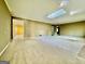 Expansive living room with a skylight, fireplace, and neutral carpet, offering an airy and inviting atmosphere at 1327 Highway 54 E, Fayetteville, GA 30214