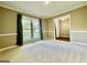 Large living room featuring a neutral palette with a big window allowing natural light and plush carpeting at 1327 Highway 54 E, Fayetteville, GA 30214