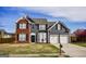 Charming two-story home with a brick and gray siding exterior, two-car garage, and well-maintained lawn at 3028 Hallman Cir, Marietta, GA 30064