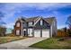 Charming two-story home showcasing brick and gray siding, a two-car garage, and a paved driveway at 3028 Hallman Cir, Marietta, GA 30064