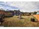 Expansive backyard showcasing a playground, lush lawn, and a charming two-story home with a dark exterior at 3028 Hallman Cir, Marietta, GA 30064