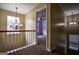 Upstairs hallway with view to a bedroom featuring decorative lighting at 3028 Hallman Cir, Marietta, GA 30064
