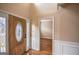 Bright foyer with hardwood floors, wainscoting, and a decorative glass front door at 3028 Hallman Cir, Marietta, GA 30064