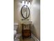 Charming powder room featuring a unique pedestal sink and round mirror at 3028 Hallman Cir, Marietta, GA 30064