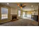 Open-concept living room with fireplace, ceiling fan, and access to the kitchen and patio at 3028 Hallman Cir, Marietta, GA 30064