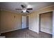 This bedroom offers neutral paint, carpet flooring, a ceiling fan, closet, and a door leading to another room at 3028 Hallman Cir, Marietta, GA 30064
