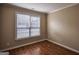 Cozy bedroom featuring hardwood floors, neutral walls, and a window providing natural light at 3028 Hallman Cir, Marietta, GA 30064