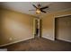 This bedroom offers neutral paint, carpet flooring, a ceiling fan, and a door leading to the bathroom at 3028 Hallman Cir, Marietta, GA 30064