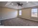 Spacious bedroom featuring a tray ceiling, fan, and natural light at 3028 Hallman Cir, Marietta, GA 30064